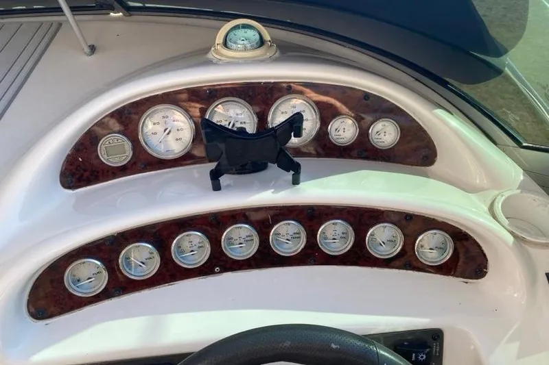 Slide: The Image of Dashboard of a 2004 Monterey 282 Cruiser with multiple gauges and a compass. - 7