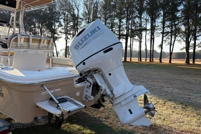 Slide: The Image of 2023 Sea Chaser 21 LX boat with Suzuki outboard motor in a wooded area. - 10