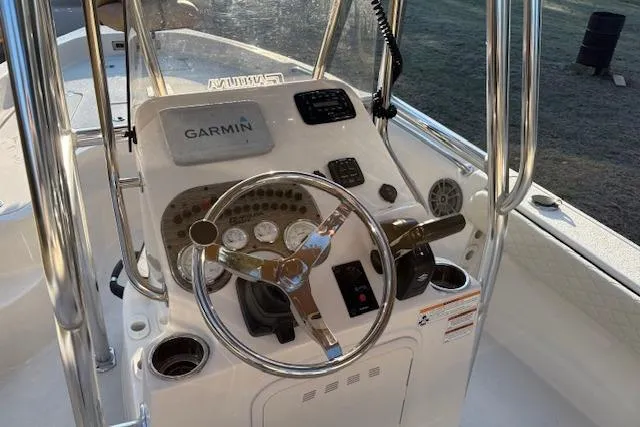 Slide: The Image of 2023 Sea Chaser 21 LX boat console with Garmin navigation system and steering wheel. - 3