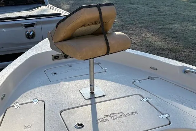 Slide: The Image of 2023 Sea Chaser 21 LX boat with cushioned seat and storage compartments. - 8