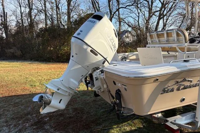 Slide: The Image of 2023 Sea Chaser 21 LX boat with Suzuki outboard motor, parked on grass. - 9