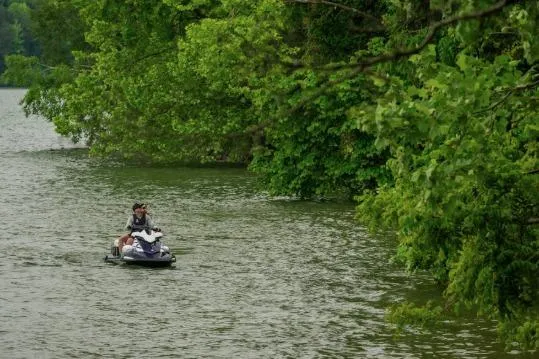 Slide: The Image of 2026 Yamaha WaveRunner VX Cruiser HO on a scenic lake surrounded by lush greenery. - 2
