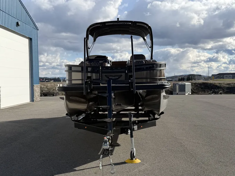 Slide: The Image of Bennington 25 RTSBA 2026 pontoon boat on trailer, cloudy sky. - 19