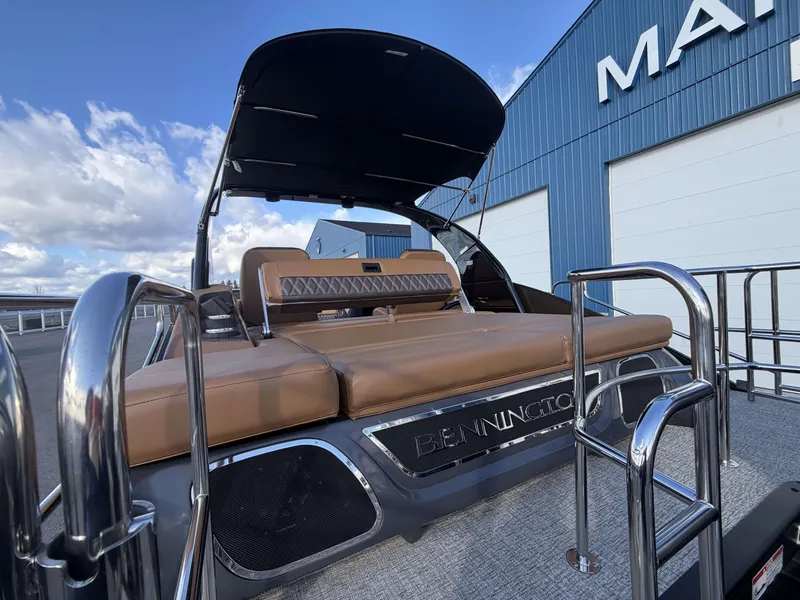 Slide: The Image of Bennington 25 RTSBA 2026 pontoon boat with brown seating and sunshade. - 24