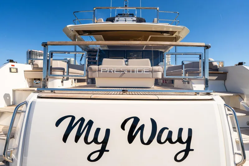 Slide: The Image of Luxury 2022 Prestige X70 yacht named "My Way" docked under clear blue sky. - 10