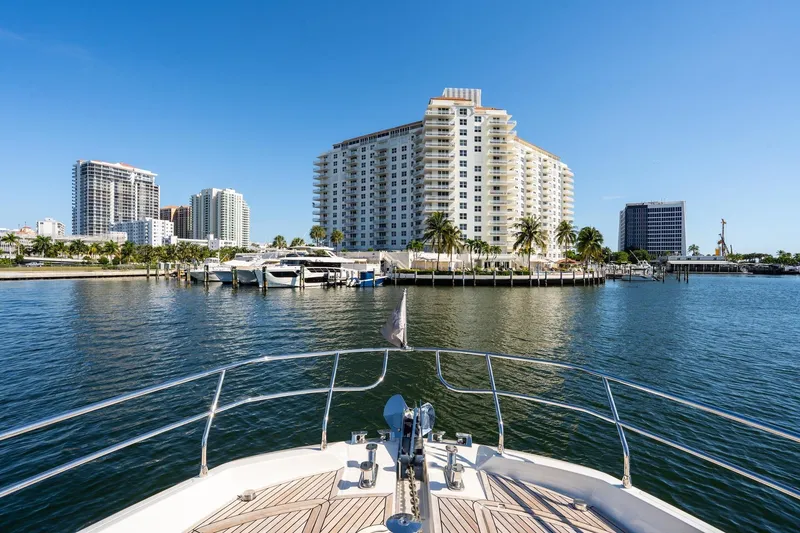 Slide: The Image of Bow view from 2022 Prestige X70 yacht, overlooking marina and waterfront buildings. - 19