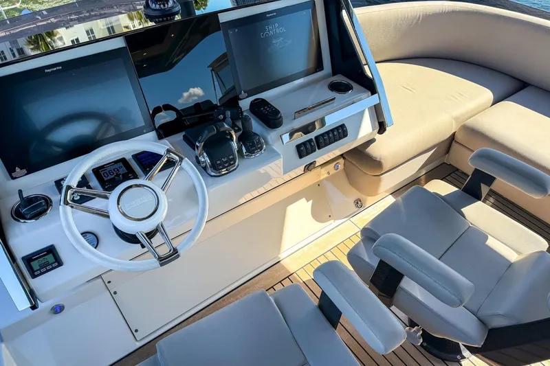 Slide: The Image of Luxury helm of 2022 Prestige X70 yacht with modern controls and seating. - 28