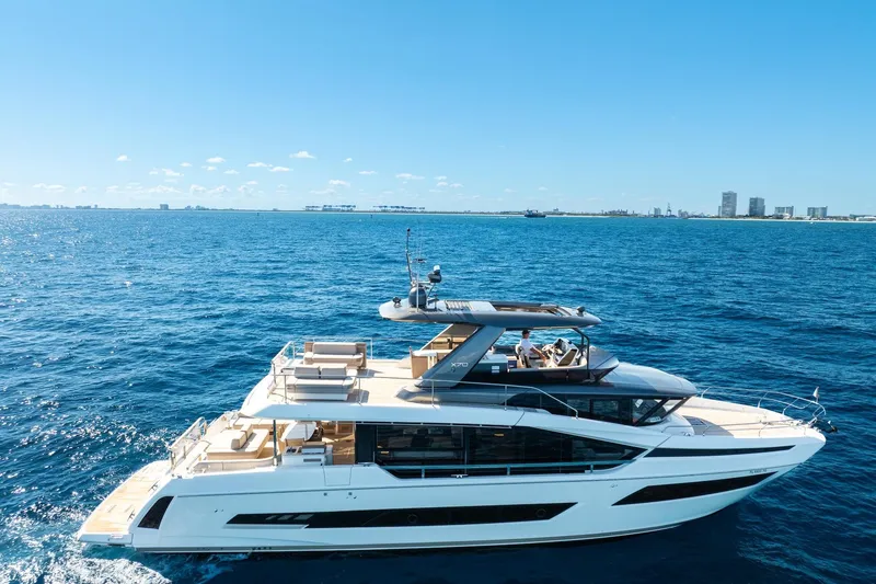 Slide: The Image of 2022 Prestige X70 yacht cruising on open blue sea under clear sky. - 4