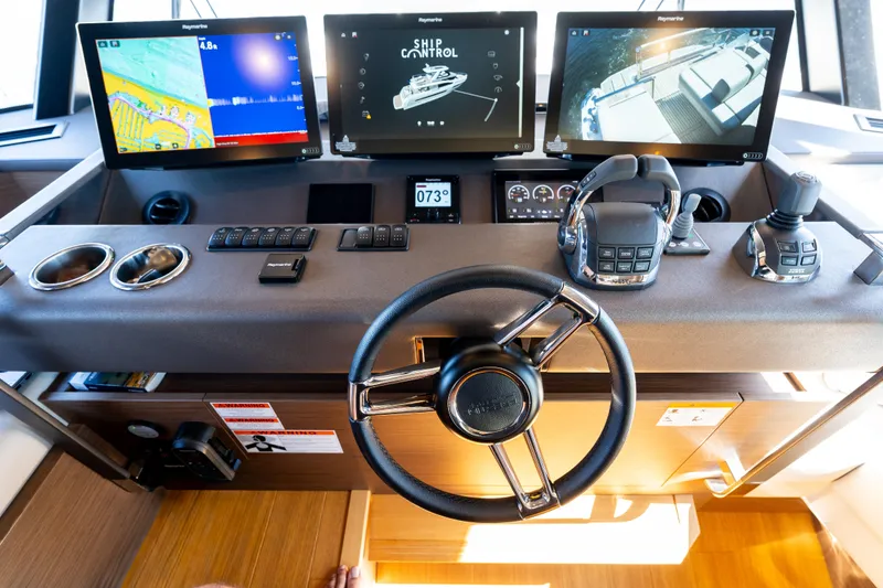 Slide: The Image of Prestige X70 2022 yacht helm with advanced navigation displays and controls. - 41