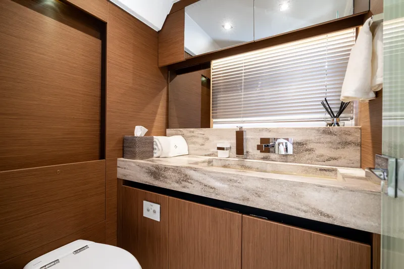 Slide: The Image of Luxurious bathroom in 2022 Prestige X70 yacht with modern fixtures and elegant wood finishes. - 54