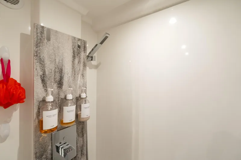 Slide: The Image of Modern shower with mounted dispensers in a 2022 Prestige X70 yacht bathroom. - 55