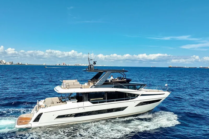 Slide: The Image of Luxury 2022 Prestige X70 yacht cruising on open blue sea under clear sky. - 8