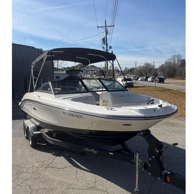 The Image of 2023 Sea Ray SPX 210 Outboard boat on trailer, parked outdoors. - 0