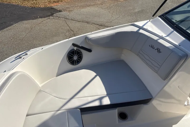 Slide: The Image of 2023 Sea Ray SPX 210 Outboard boat interior with cushioned seating and speaker. - 18