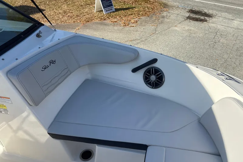 Slide: The Image of 2023 Sea Ray SPX 210 Outboard boat interior with cushioned seating and speaker. - 19