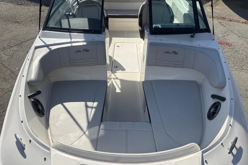 Slide: The Image of 2023 Sea Ray SPX 210 Outboard boat interior with white seating and Sea Ray logo. - 20