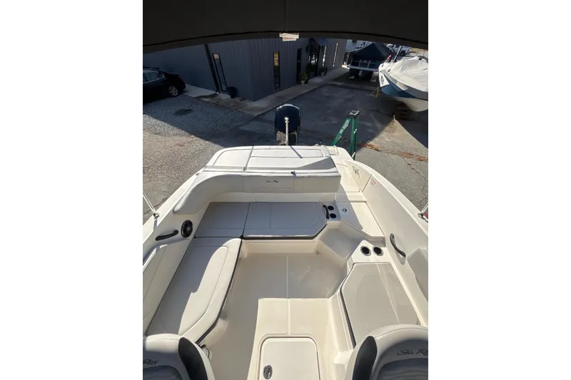 Slide: The Image of 2023 Sea Ray SPX 210 Outboard boat interior with seating and storage. - 21