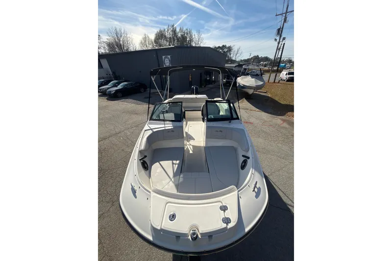 Slide: The Image of 2023 Sea Ray SPX 210 Outboard boat, white exterior, parked outdoors under clear sky. - 3