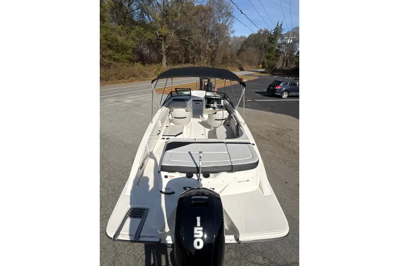 Slide: The Image of 2023 Sea Ray SPX 210 Outboard boat with black canopy and Mercury engine. - 4