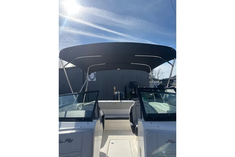Slide: The Image of 2023 Sea Ray SPX 210 Outboard boat with canopy under sunny sky. - 6