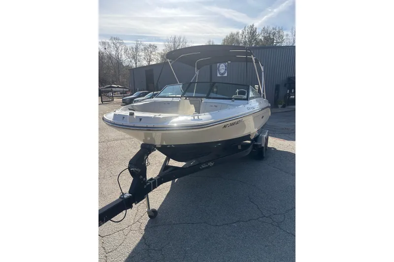 Slide: The Image of 2023 Sea Ray SPX 210 Outboard boat on trailer, parked outdoors. - 7