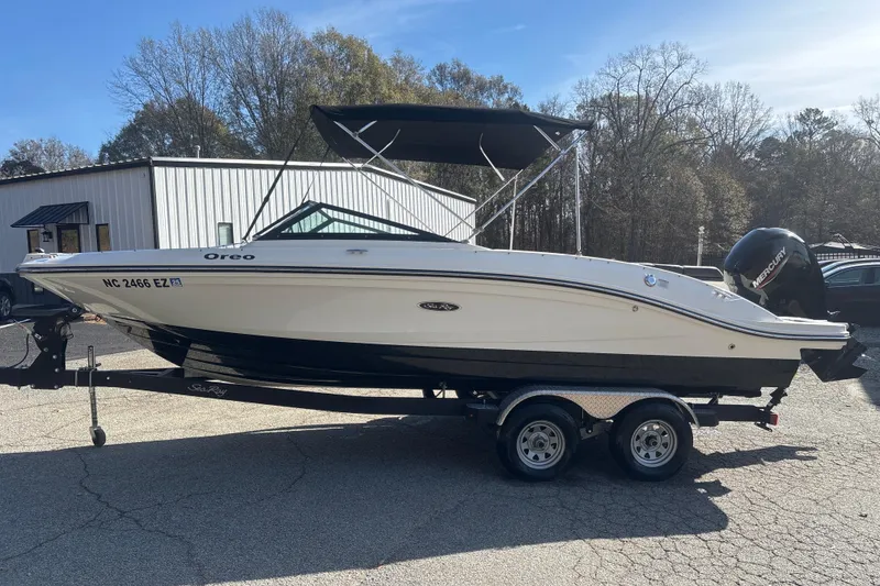 Slide: The Image of 2023 Sea Ray SPX 210 Outboard boat on trailer, parked outdoors. - 8