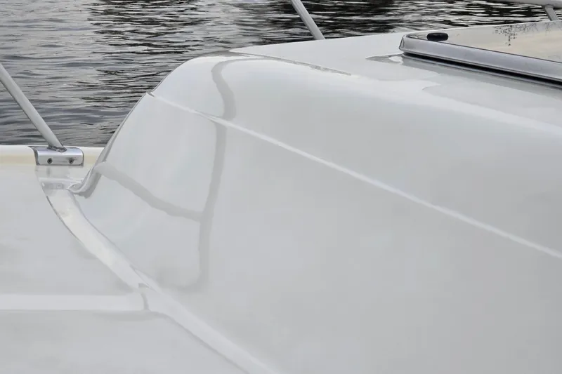 Slide: The Image of 2001 Mainship 30 Pilot Rum Runner boat detail with water reflection. - 11