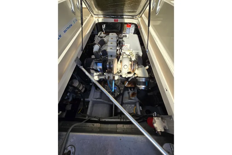 Slide: The Image of Engine compartment of 2001 Mainship 30 Pilot Rum Runner boat, showcasing mechanical components. - 16