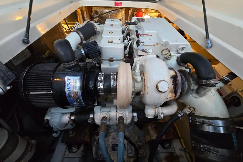 Slide: The Image of Engine compartment of 2001 Mainship 30 Pilot Rum Runner boat, showcasing detailed machinery. - 17