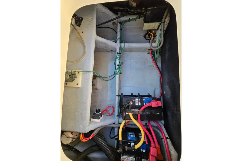 Slide: The Image of Engine compartment of 2001 Mainship 30 Pilot Rum Runner with wiring and battery setup. - 20