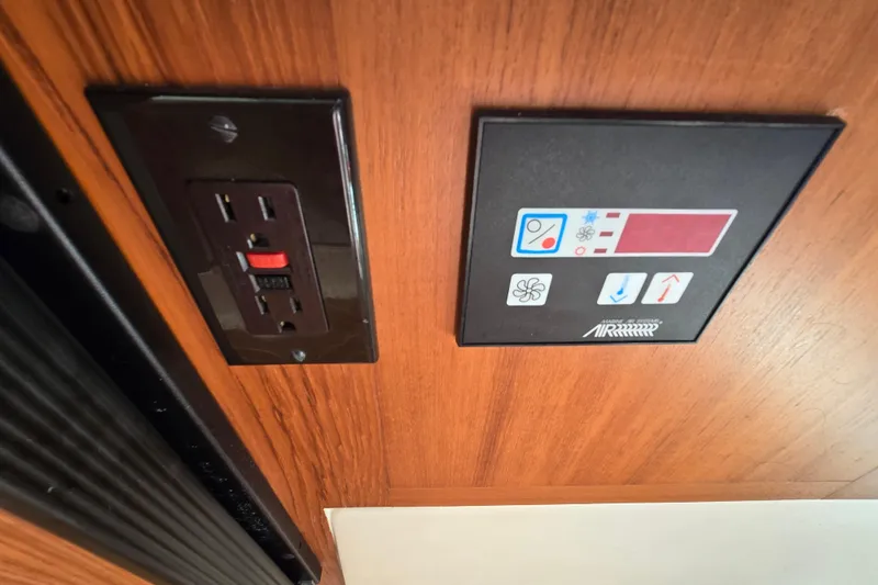 Slide: The Image of Control panel and outlet on 2001 Mainship 30 Pilot Rum Runner boat interior. - 21