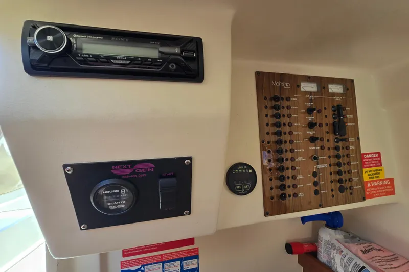 Slide: The Image of 2001 Mainship 30 Pilot Rum Runner control panel with Sony stereo and electrical switches. - 24