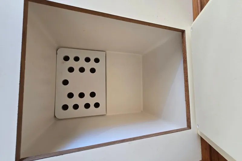 Slide: The Image of Storage compartment with perforated base on 2001 Mainship 30 Pilot Rum Runner boat. - 29
