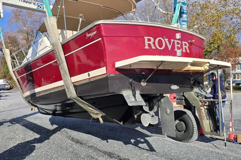 Slide: The Image of 2001 Mainship 30 Pilot Rum Runner boat being lifted, red hull, named "Rover." - 41