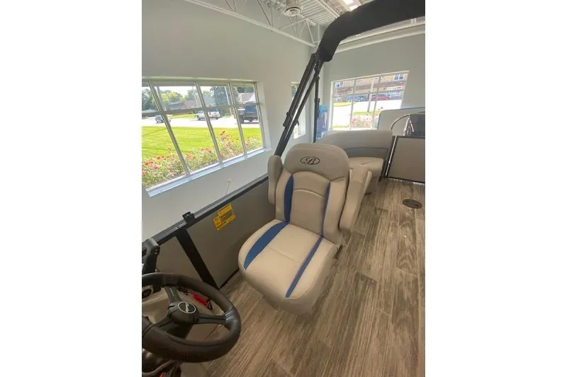 Slide: The Image of 2026 Bentley Pontoons Bolt interior with modern seating and steering wheel, showcasing luxury design. - 14