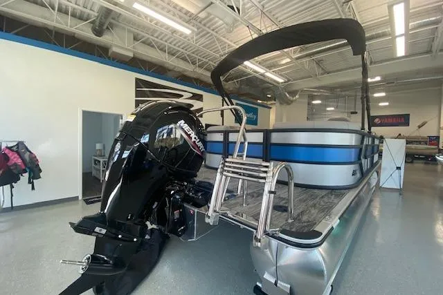 Slide: The Image of 2026 Bentley Pontoons Bolt with Mercury outboard motor in showroom. - 2