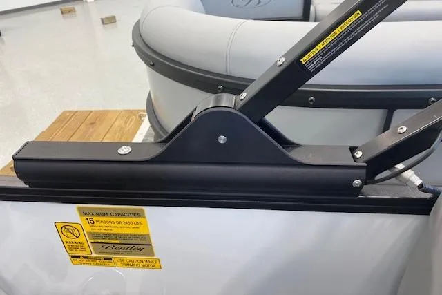 Slide: The Image of 2026 Bentley Pontoons Legacy 223 Navigator interior detail with seating and safety labels. - 15