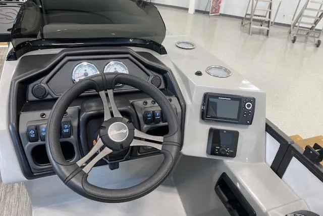 Slide: The Image of 2026 Bentley Pontoons Legacy 223 Navigator dashboard with steering wheel and control panel. - 9