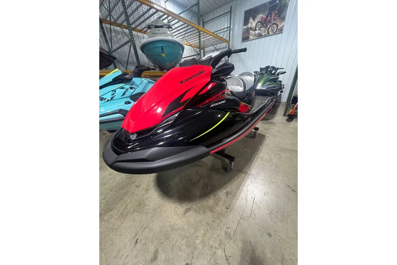 Slide: The Image of 2025 Kawasaki Jetski STX 160LX in showroom, vibrant red and black design. - 2