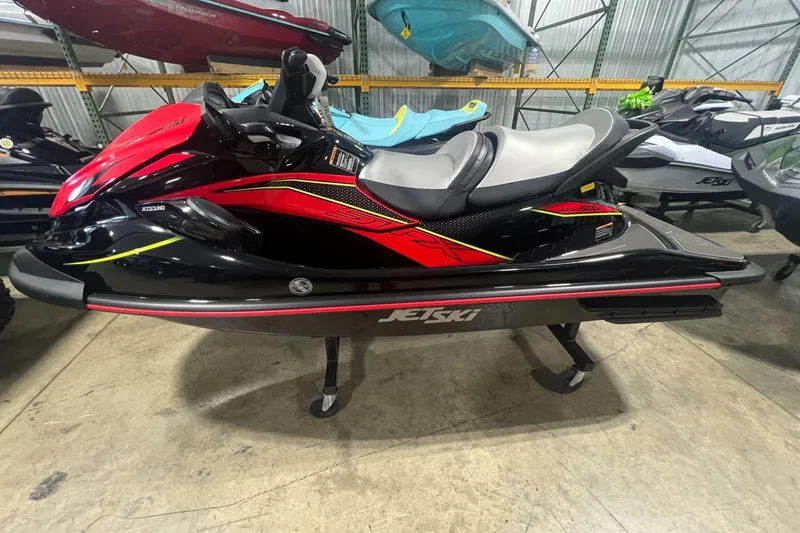 Slide: The Image of 2025 Kawasaki Jetski STX 160LX in showroom, featuring sleek red and black design. - 3