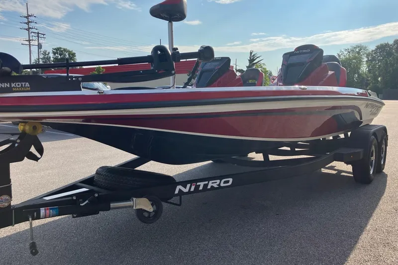 Slide: The Image of 2026 Nitro Z19 XL boat on trailer, red and white design, parked outdoors. - 3