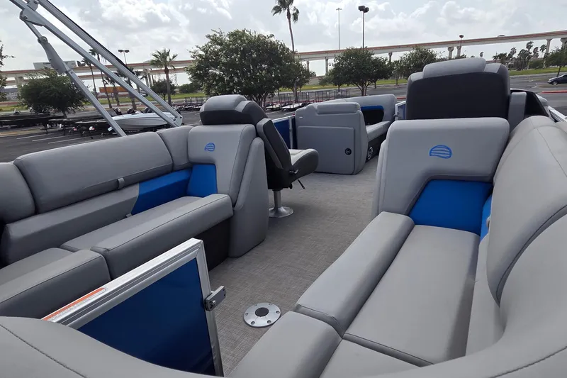 Slide: The Image of 2026 Sun Tracker Party Barge 22 DLX interior with gray and blue seating. - 9