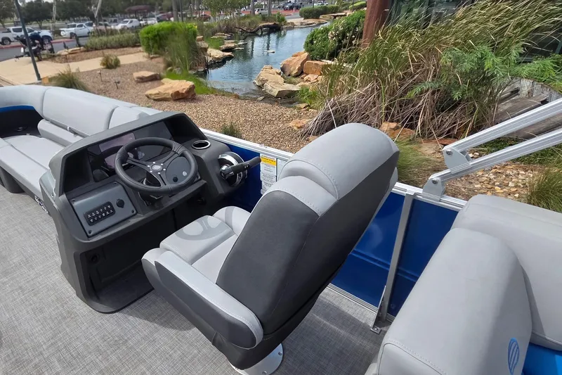 Slide: The Image of 2026 Sun Tracker Party Barge 22 DLX interior with steering console and seating. - 6