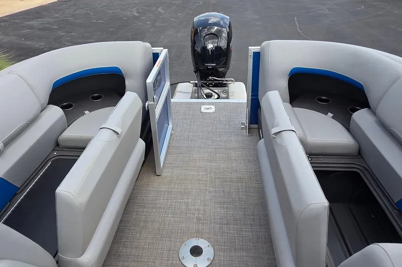 Slide: The Image of 2026 Sun Tracker Party Barge 22 DLX interior with seating and outboard motor. - 11