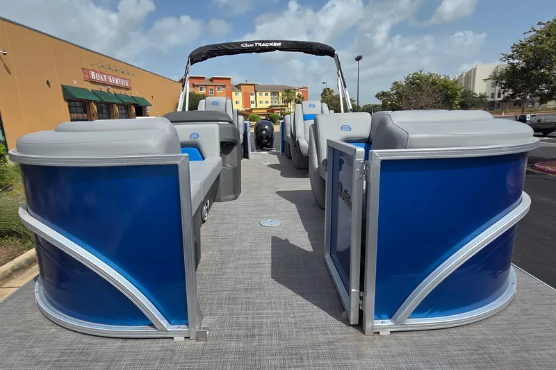 Slide: The Image of 2026 Sun Tracker Party Barge 22 DLX pontoon boat with blue panels and gray seating. - 1