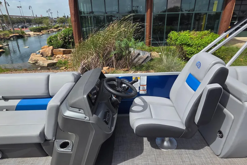 Slide: The Image of 2026 Sun Tracker Party Barge 22 DLX interior with steering console and seating. - 4
