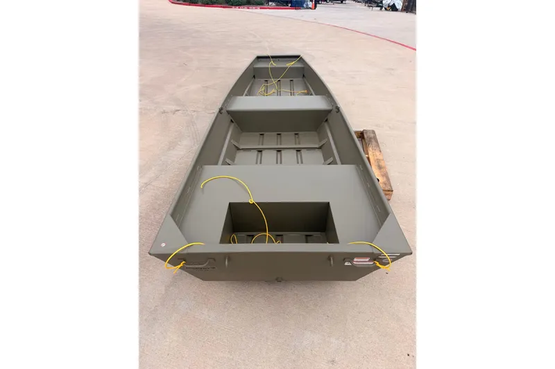 Slide: The Image of 2026 Tracker Grizzly 14 Jon boat on concrete surface, showcasing interior layout. - 2