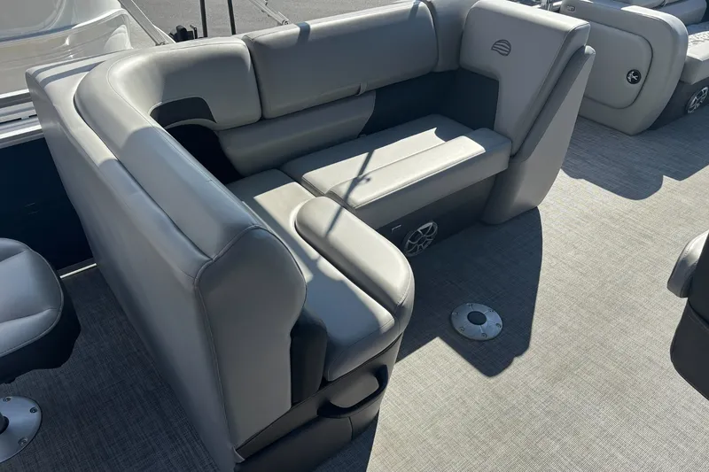 Slide: The Image of 2026 Sun Tracker SportFish 22 DLX boat interior with gray seating and carpeted flooring. - 13