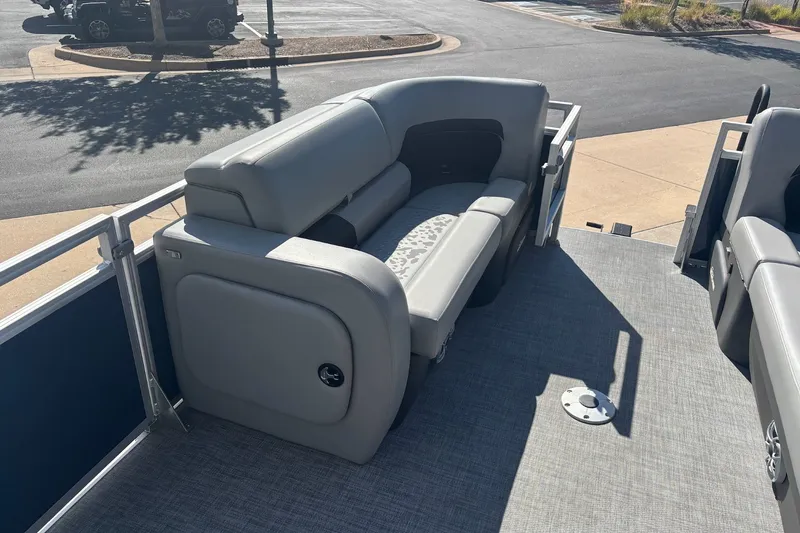 Slide: The Image of 2026 Sun Tracker SportFish 22 DLX pontoon boat with gray seating and spacious deck. - 15