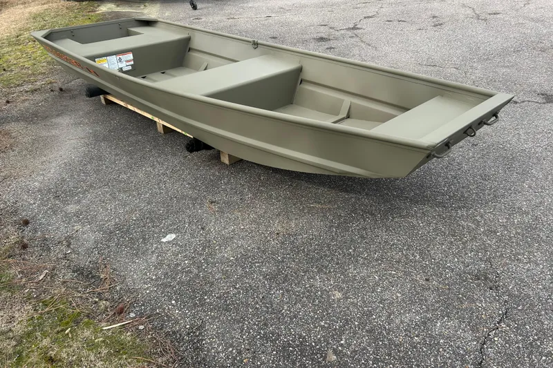 The Image of 2026 Tracker Grizzly 14 Jon boat on pavement, showcasing its sturdy design. - 0